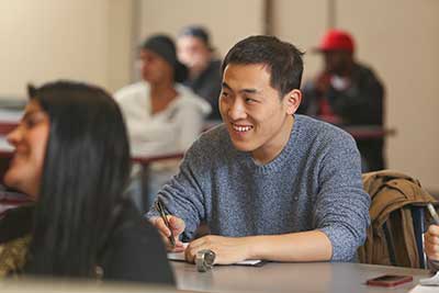 Student in class at Highline College smiling