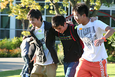 International Student Programs fall orientation group walking across the grass on campus