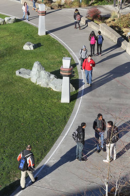 Highline College students walking on pathway between the library and student union