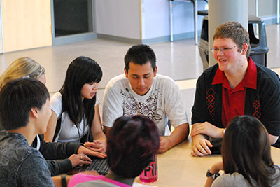 Highline College students sitting around a table in the student union